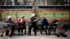 FILE - A group of elderly women rest in their wheelchairs at a residential compound in Beijing, China.