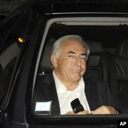 Former IMF chief Dominique Strauss-Kahn leaves his apartment, hours after being questioned by police, in Paris September 12, 2011.