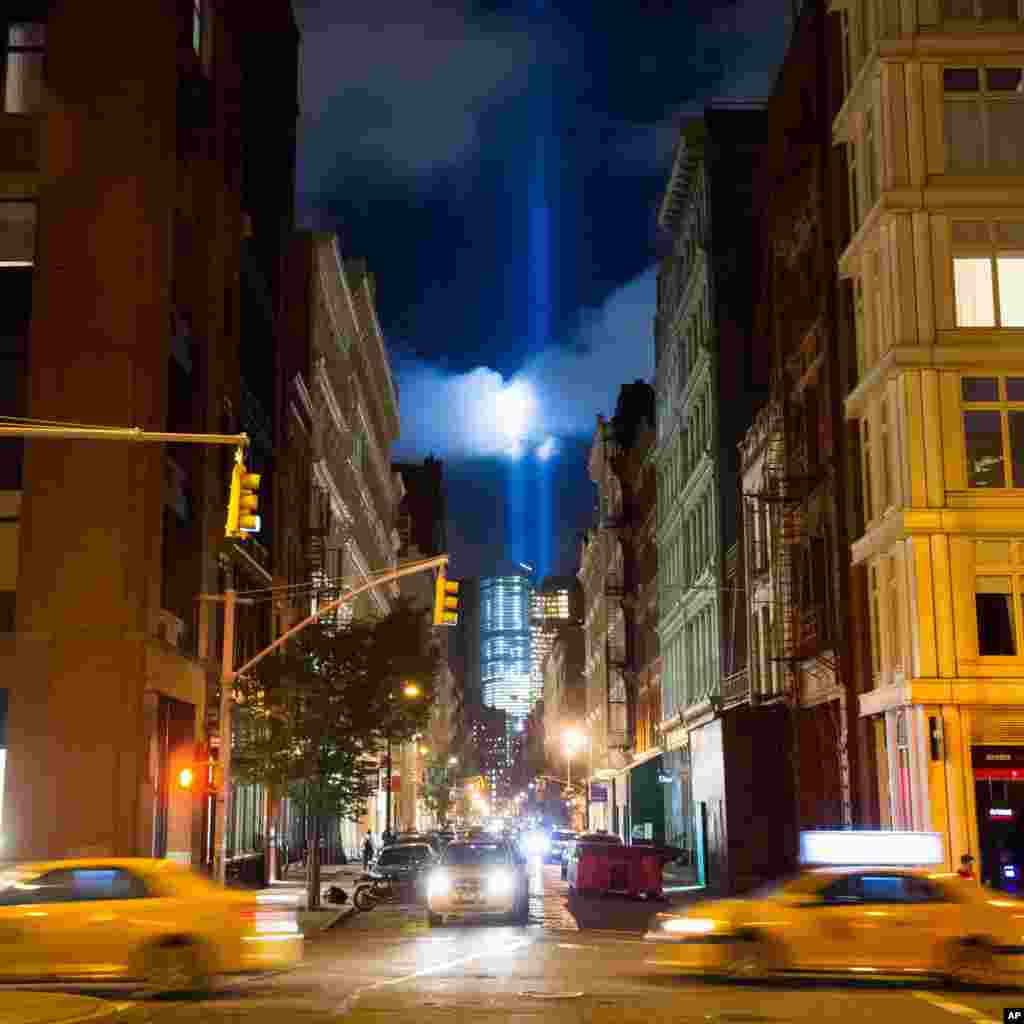 The Tribute in Light rises behind buildings adjacent to the World Trade Center complex at the National September 11 Memorial, New York, Sept. 8, 2014.