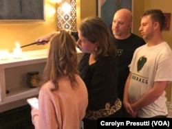 Sara Stock Mayo lights a Yahrzeit candle in honor of her father who died three years ago and another one for the eleven who died in Saturday’s synagogue shooting. The candles will stay lit in the Mayos dining room for 24 hours.