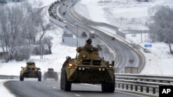 A convoy of Russian armored vehicles moves along a highway in Crimea, Jan. 18, 2022.
