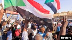 FILE - Protesters march during a rally against military rule following a coup nearly three months ago, in Khartoum, Sudan, Jan. 24, 2022.