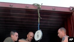 In this picture taken on October 14 , 2011 French soldiers load cases before leaving the Torah base in the district of Surobi, about 50 kms (30 miles) east of Kabul, Afghanistan.