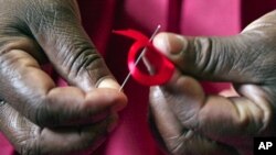 Kenyan woman prepares ribbons ahead of World Aids Day at Beacon of Hope center in Nairobi, Dec. 2010 (file photo).