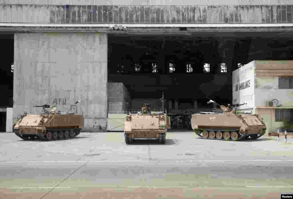 Armored personal carriers are seen at Jinnah International Airport after Sunday's attack by Taliban militants, in Karachi, Pakistan, June 10, 2014. 