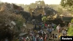 FILE - Excavators work after a landslide at a garbage dump on the outskirts of Addis Ababa, Ethiopia in this still image taken from a video from March 12, 2017.