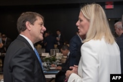 Canadian ecology minister Catherine McKenna (R) confers with American Deputy Assistant to the President for International Economic Affairs and Deputy Director of the National Economic Council Everett Eissenstat (C) during the meeting of environmental ministers in Montreal, Sept. 16, 2017.