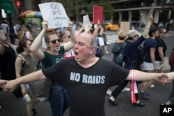 Demonstrators march across Central Park South during "100 Days of Failure" protest and march, April 29, 2017, in New York. Thousands of people across the U.S. marked President Donald Trump's hundredth day in office by marching in protest.