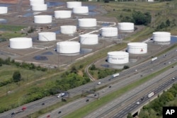 FILE - Traffic on I-95 passes Citgo oil storage tanks in Linden, N.J., Sept. 8, 2008.