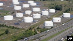 FILE - Traffic on I-95 passes Citgo oil storage tanks in Linden, N.J., Sept. 8, 2008. Venezuela will hold onto its U.S.-based Citgo refineries, settling in Nov. 2018 a lawsuit that threw ownership of the struggling country’s prized assets into peril. 