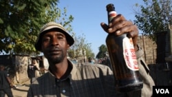 On a Friday evening in Diepsloot, the streets are filled with men drinking. (D. Taylor/VOA)