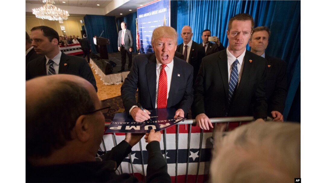 Republican presidential candidate Donald Trump signs autographs during a campaign stop at the Radisson Hotel in Nashua, New Hampshire, Jan. 29, 2016.
