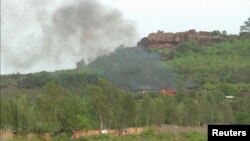 Flames rise following an attack where gunmen stormed Le Campement Kangaba resort in Dougourakoro, east of Bamako, Mali, in this still frame taken from video June 18, 2017. 