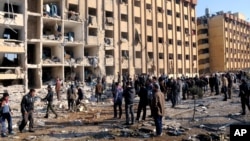 In this photo released by the Syrian official news agency SANA, Syrian people gather at the site after an explosion hit a university in Aleppo, Syria, Jan. 15, 2013.
