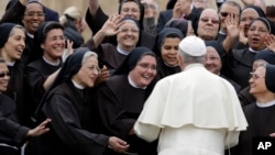 FILE - Pope Francis meets a group of Franciscan nuns during his weekly general audience, in St. Peter's Square, at the Vatican, Wednesday, May 9, 2018. (AP Photo/Andrew Medichini)