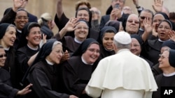FILE - Pope Francis meets a group of Franciscan nuns during his weekly general audience, in St. Peter's Square, at the Vatican, Wednesday, May 9, 2018. 