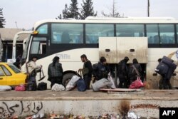 Syrian rebel fighters arrive in the opposition-controlled Khan al-Assal region, west of Aleppo, after being evacuated from the embattled city, Dec. 22, 2016.