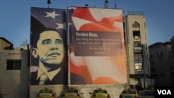 A Palestinian protest sign tells President Obama his smart phone will not work on the West Bank. Photo: VOA / R.Collard