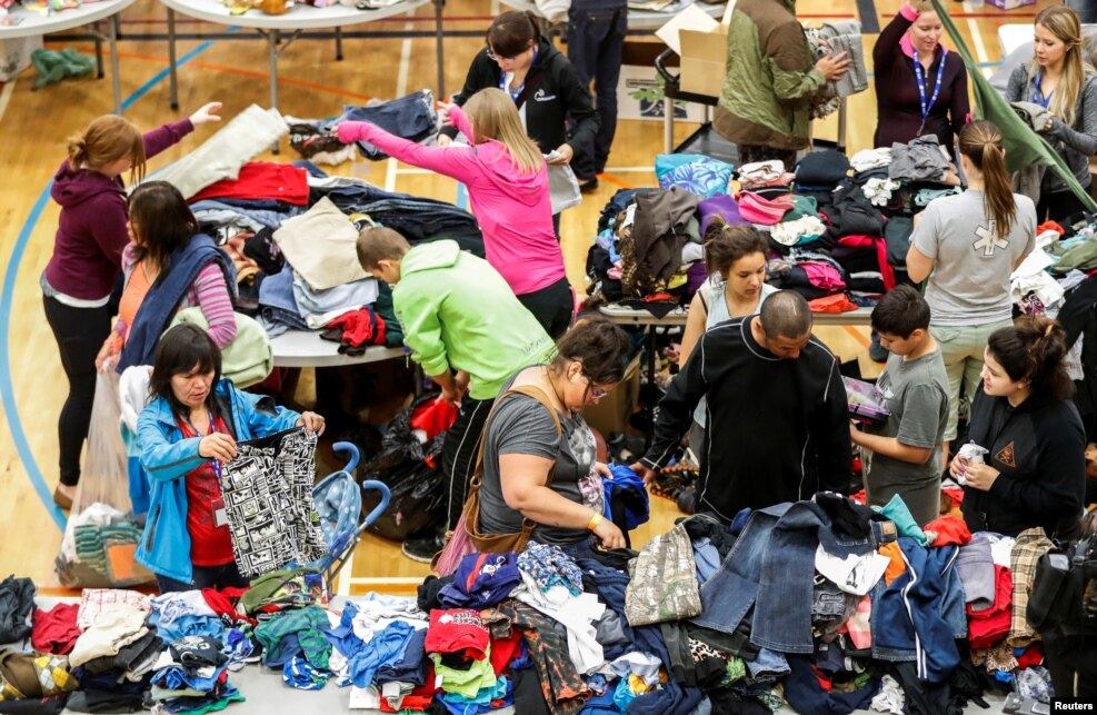 Evacuees from the Fort McMurray wildfires look through donated goods and clothing at the "Bold Center" in Lac la Biche, Alberta, Canada.