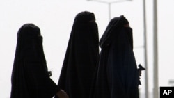 FILE - Saudi women walk along a suburban street in Riyadh, Saudi Arabia.