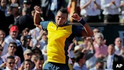 France's Jo-Wilfried Tsonga celebrates defeating Switzerland's Roger Federer in three sets 7-5, 6-3, 6-3, in their quarterfinal match at the French Open tennis tournament, at Roland Garros stadium in Paris, June 4, 2013.
