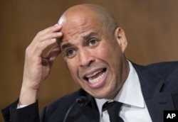 FILE - Sen. Cory Booker, D-N.J., questions Secretary of State-designate Rex Tillerson as he testifies on Capitol Hill in Washington, Jan. 11, 2017.