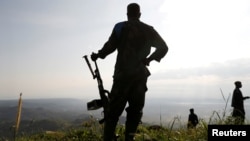 Soldiers stand in an Armed Forces of Democratic Republic of Congo field camp in Paida near Beni, North Kivu Province of Democratic Republic of Congo, Dec. 7, 2018. 