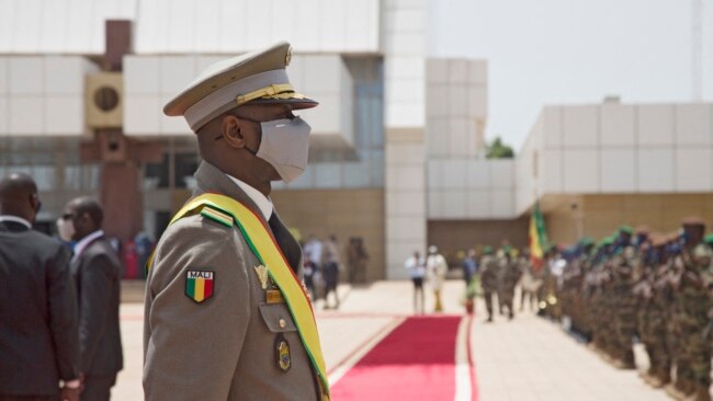 FILE - Interim Malian President, Colonel Assimi Goita, looks on at members of the Malian Armed Forces after his swearing in ceremony in Bamako on June 7, 2021.