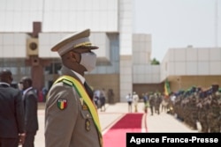 FILE - The new interim Malian President, Colonel Asimi Goita, looks at members of the Malian Armed Forces after his swearing-in ceremony in Bamako on June 7, 2021.