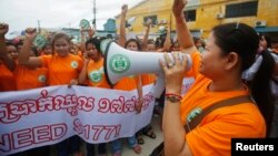 FILE: Garment workers shout during a protest calling for higher wages in Phnom Penh September 17, 2014.