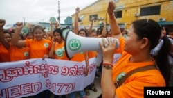 Garment workers shout during a protest calling for higher wages in Phnom Penh September 17, 2014. 