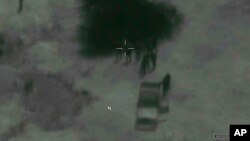 In this image from video released by the Department of Defense, Niger military members arrive at the scene where the body of Army Sgt. La David T. Johnson, 25, of Miami Gardens, Fla., was recovered after an ambush that killed four U.S. service members in Niger.
