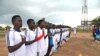 FILE- South Sudan's new football team lines up to sing the national anthem wearing South Sudan shirts for
the first time, June 28, 2012.
