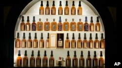 FILE- Bottles of bourbon are shown in a display case at the Heaven Hill Bourbon Heritage Center in Bardstown, Ky., April 8, 2009.