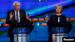 U.S. Senator Bernie Sanders debates former Secretary of State Hillary Clinton during the first official Democratic candidates debate of the 2016 presidential campaign in Las Vegas, Oct. 13, 2015.