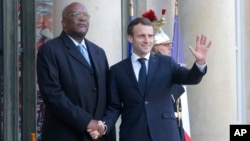 Burkina Faso's President Roch Marc Christian Kabore, left, is welcomed by French President Emmanuel Macron at the Elysee Palace in Paris, France, Dec. 17, 2018.