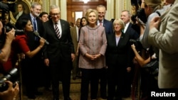 Democratic U.S. presidential candidate Hillary Clinton walks with Senate Minority Leader Harry Reid (D-Nev.) (L), Senator Chuck Schumer (D-N.Y.) (3rd R), Senator Patty Murray (D-Wash.) (2nd R) and Senator Dick Durbin (D-Ill.) (R) as she arrives to meet with Senate Democrats during their luncheon gathering at the U.S. Capitol in Washington, July 14, 2016.
