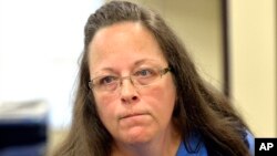 Rowan County Clerk Kim Davis listens to a customer following her office's refusal to issue marriage licenses at the Rowan County Courthouse in Morehead, Ky., Sept. 1, 2015. 