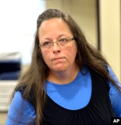 FILE - Rowan County Clerk Kim Davis listens to a customer following her office's refusal to issue marriage licenses at the Rowan County Courthouse in Morehead, Ky., Sept. 1, 2015.