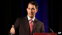 FILE - Wisconsin Gov. Scott Walker, shown in June, becomes the 15th candidate to enter the crowded Republican field for president.