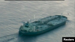 A still image from video taken by a U.S. Coast Guard HC-144 Ocean Sentry aircraft shows the oil tanker United Kalavyrta (also known as the United Kalavrvta), which is carrying a cargo of Kurdish crude oil, approaching Galveston, Texas, July 25, 2014. 