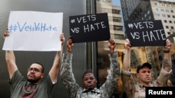 FILE - U.S. military veterans (R-L) Perry O'Brien, Claude Copeland and Julio Torres demonstrate outside Republican presidential candidate Donald Trump's news conference outside Trump Tower in New York, May 31, 2016. 