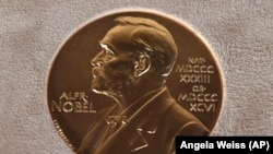 FILE - A Tuesday, Dec. 8, 2020 file photo of a Nobel medal displayed during a ceremony in New York.
