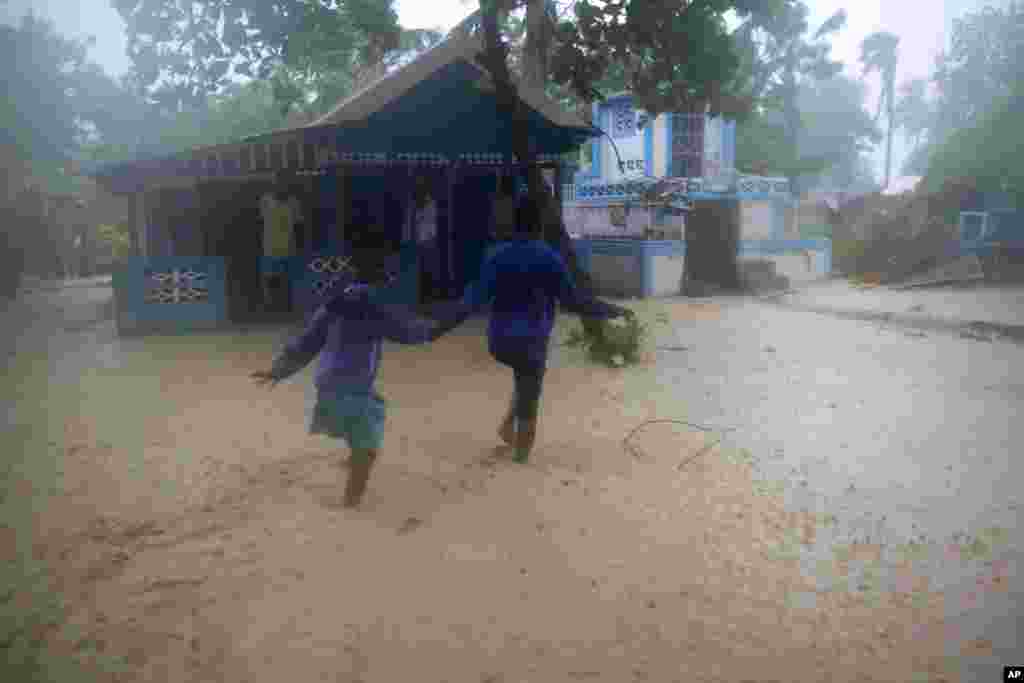 Residents wade through flood waters in Leogane, Haiti, Oct. 4, 2016