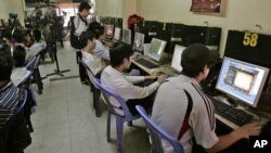FILE - Students surf web at an Internet cafe in Hanoi, Vietnam, March 31, 2010. 