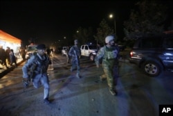 Afghan security forces rush to respond to a complex Taliban attack on the campus of the American University in Kabul, Aug. 24, 2016.