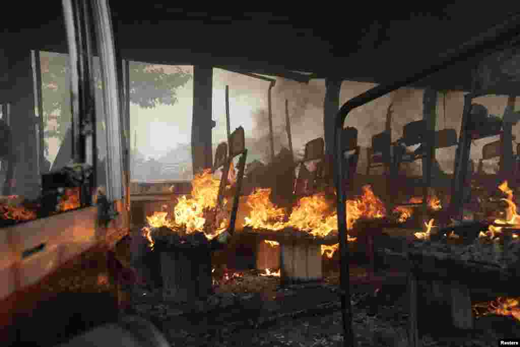 A bus is seen ablaze after activists of the Bangladesh Nationalist Party (BNP) set fire to it during a nationwide blockade in Kachpur near Dhaka December 9, 2012. Police fired rubber bullets and tear gas to disperse protesters staging blockades across Ban