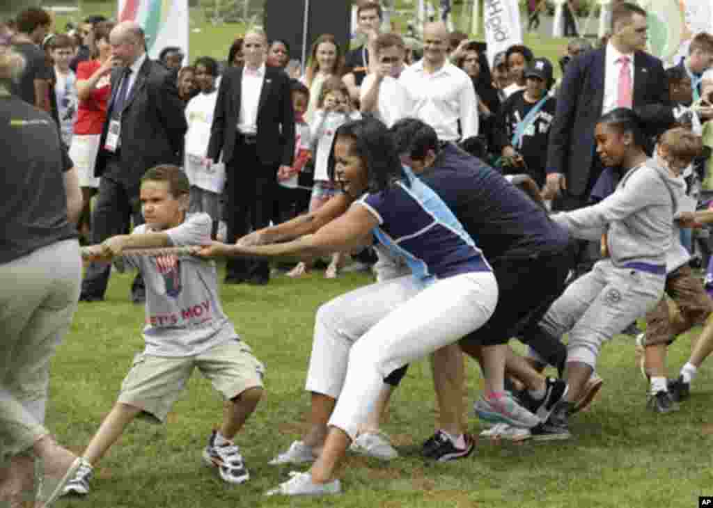 U.S. first lady Michelle Obama plays with schoolchildren during a 'Let's Move!' event for about 1,000 American military children and American and British students at the U.S. ambassador's residence in London, ahead of the 2012 Summer Olympics, Friday, Jul
