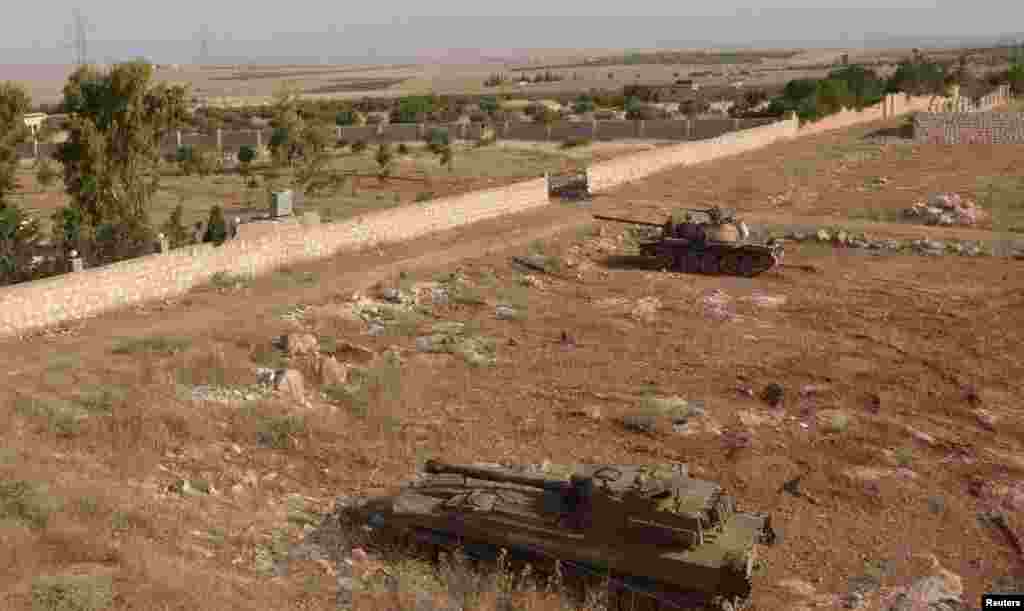 Tanks belonging to forces loyal to Syria's President Bashar al-Assad are seen in al-Mansoura in the Aleppo countryside, June 2, 2013.