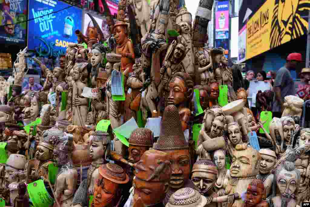 People look at a pile of artwork made out of ivory during a ceremony at Times Square in New York. The U.S. Fish and Wildlife Service destroyed more than one ton of confiscated illegal ivory in a public show to raise awareness of the elephant poaching and wildlife trafficking crisis.